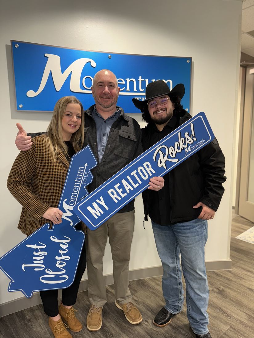 Adrian Arizmendi with clients after a successful sale